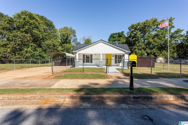 bungalow-style house featuring a front yard and a carport