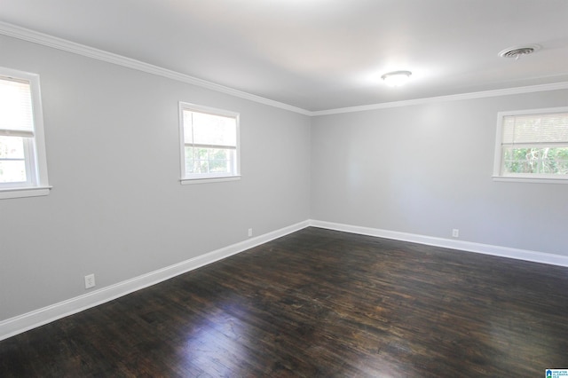 empty room with ornamental molding and dark wood-type flooring