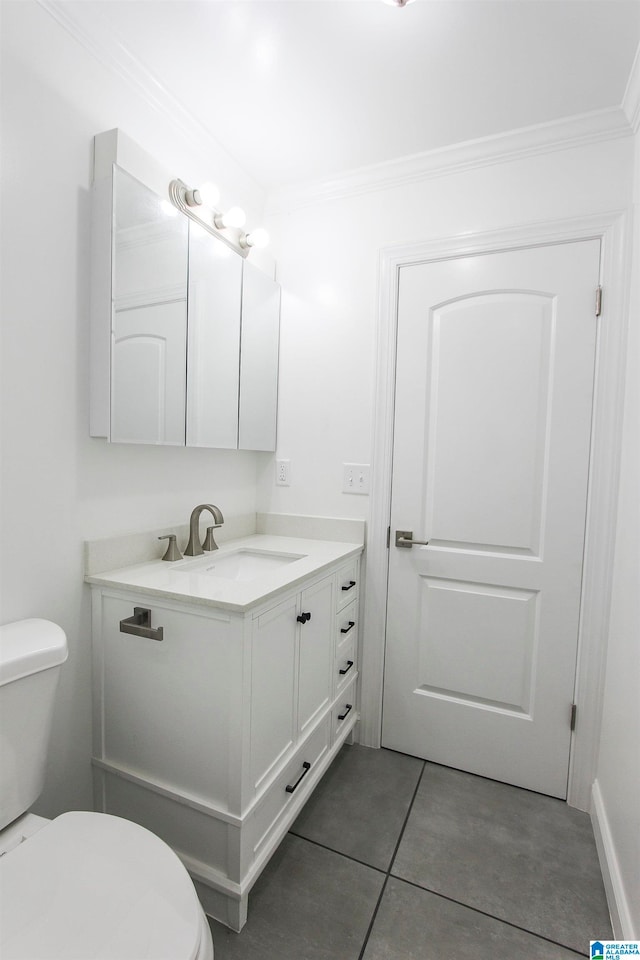 bathroom with tile patterned flooring, vanity, toilet, and crown molding