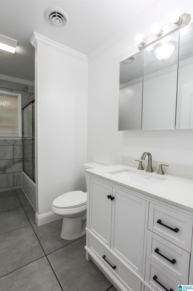 full bathroom featuring vanity, crown molding, tile patterned flooring, toilet, and enclosed tub / shower combo