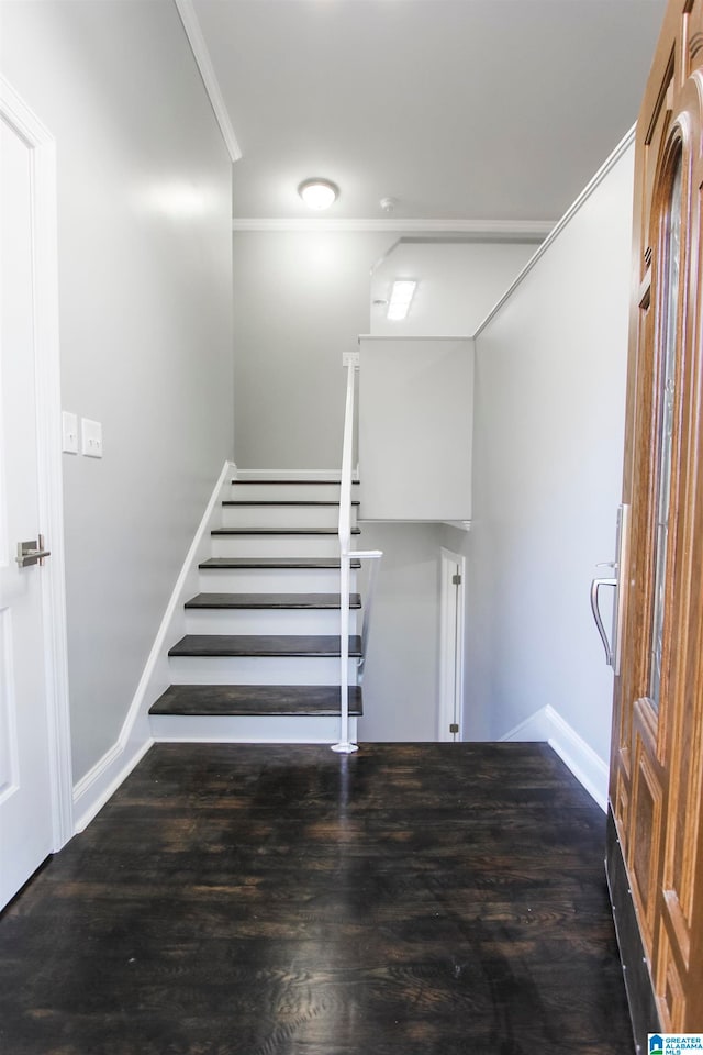 stairs featuring crown molding and hardwood / wood-style flooring