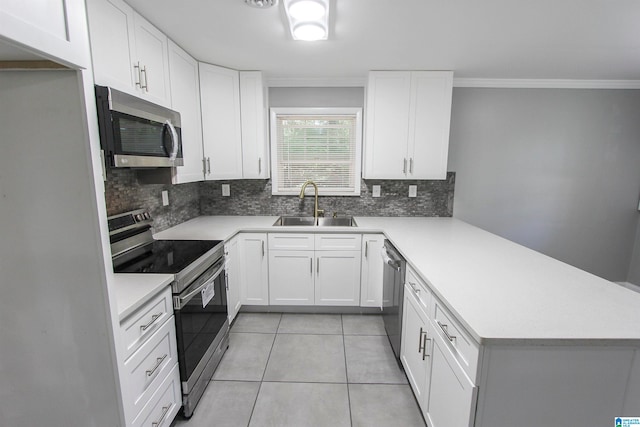 kitchen featuring backsplash, sink, light tile patterned floors, white cabinetry, and stainless steel appliances