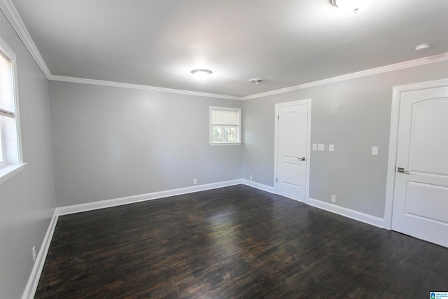 spare room featuring crown molding and dark hardwood / wood-style flooring