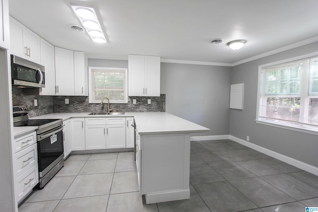 kitchen with white cabinetry, sink, kitchen peninsula, light tile patterned floors, and appliances with stainless steel finishes