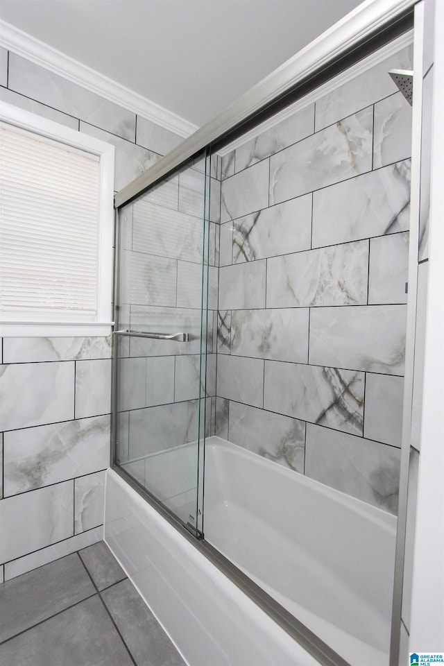 bathroom with tile patterned floors, ornamental molding, and enclosed tub / shower combo