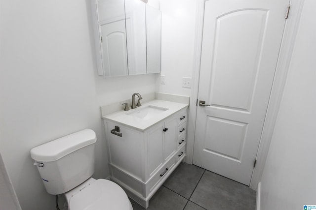 bathroom with tile patterned flooring, vanity, and toilet