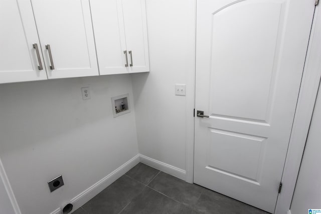 laundry area featuring hookup for an electric dryer, washer hookup, cabinets, and dark tile patterned flooring