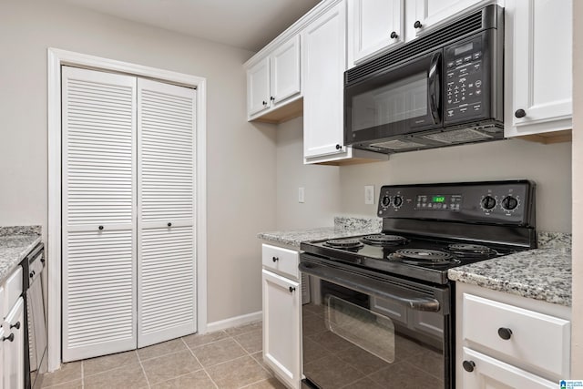 kitchen featuring white cabinets, black appliances, light stone counters, and light tile patterned floors