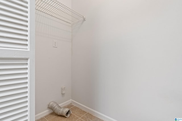 washroom with light tile patterned flooring and electric dryer hookup