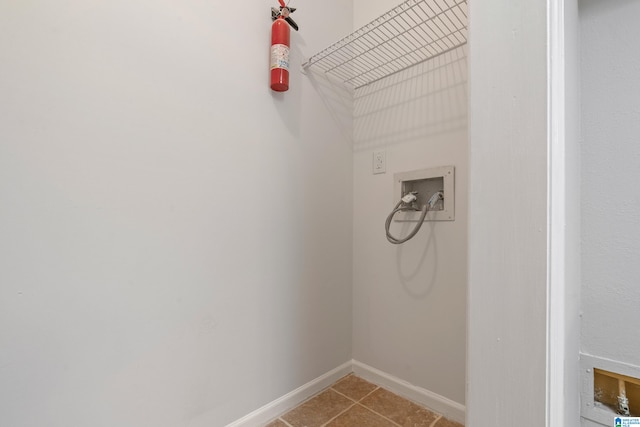 laundry area with washer hookup and light tile patterned floors