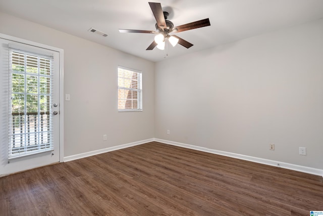 empty room with dark hardwood / wood-style flooring and ceiling fan