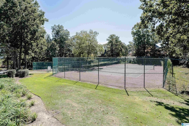 view of tennis court with a lawn