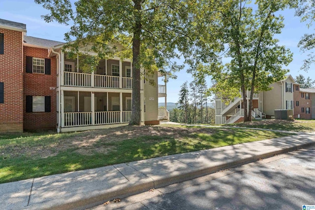 exterior space featuring a front yard and a balcony