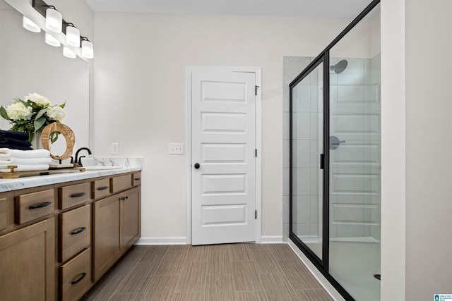 bathroom featuring walk in shower and vanity