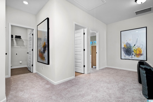 hallway with light colored carpet