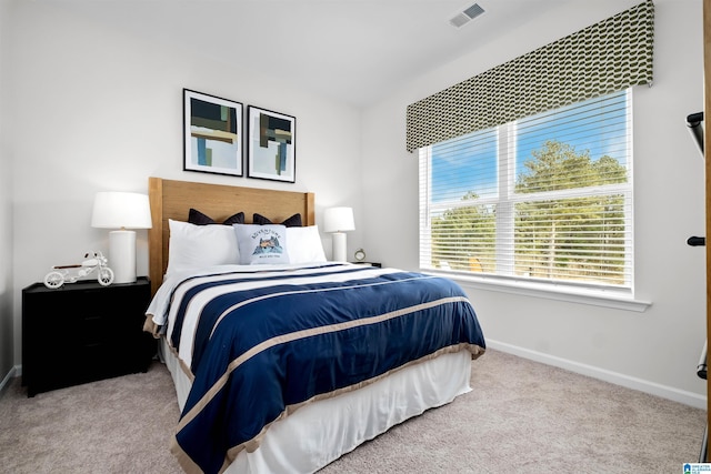 bedroom featuring light carpet