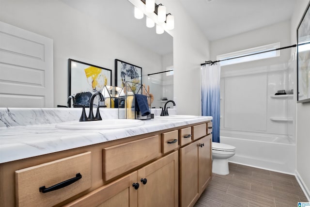 full bathroom featuring toilet, vanity, and shower / bathtub combination with curtain