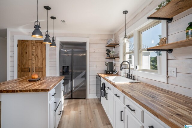 21023 Monroe Dunn Rd, Berry, AL 35546 - kitchen featuring hanging light fixtures, wooden counters, white cabinetry, and stainless steel refrigerator with ice dispenser