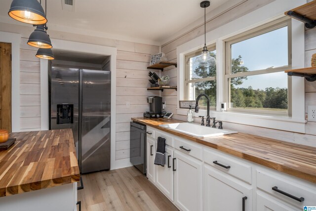 21023 Monroe Dunn Rd, Berry, AL 35546 - kitchen with hanging light fixtures, stainless steel fridge, and wood counters