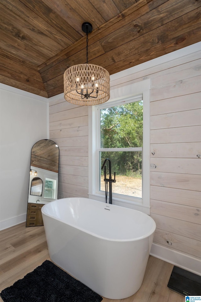 21023 Monroe Dunn Rd, Berry, AL 35546 - bathroom with a tub to relax in, lofted ceiling, wood ceiling, and wood-type flooring