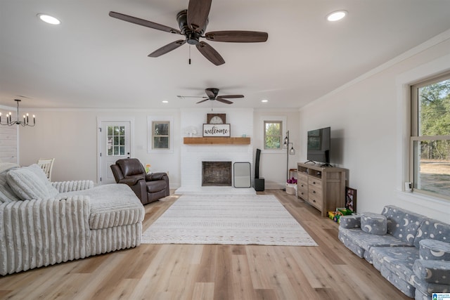 21023 Monroe Dunn Rd, Berry, AL 35546 - living room with crown molding, light hardwood / wood-style floors, and ceiling fan with notable chandelier