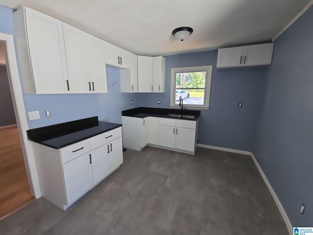 kitchen with white cabinetry and sink