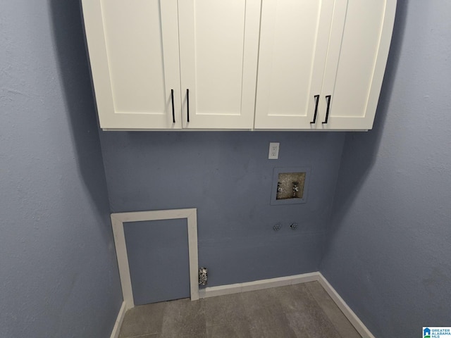 laundry area with hardwood / wood-style flooring, hookup for a washing machine, gas dryer hookup, and cabinets