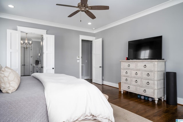 bedroom featuring ornamental molding, ceiling fan with notable chandelier, dark wood-type flooring, and connected bathroom