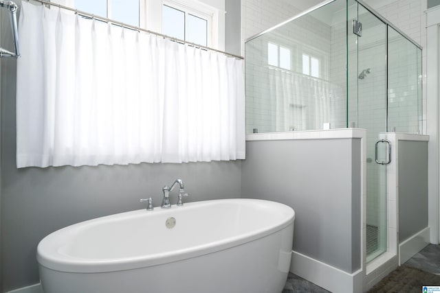 bathroom featuring separate shower and tub