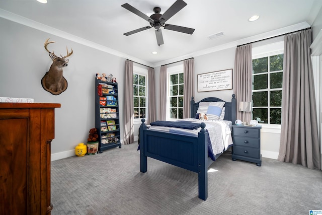 bedroom featuring ceiling fan, crown molding, and multiple windows