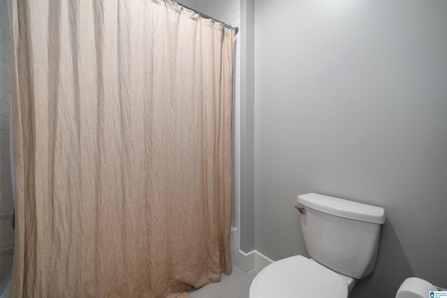 bathroom with shower / bath combo and toilet