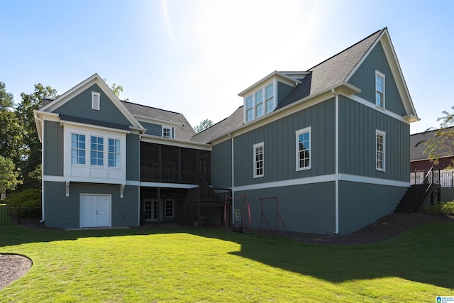 rear view of property featuring a sunroom and a yard