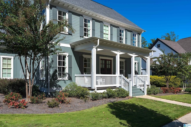 view of front of property featuring a front lawn and covered porch