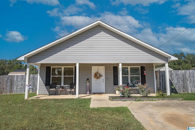 bungalow-style house featuring a front lawn and covered porch