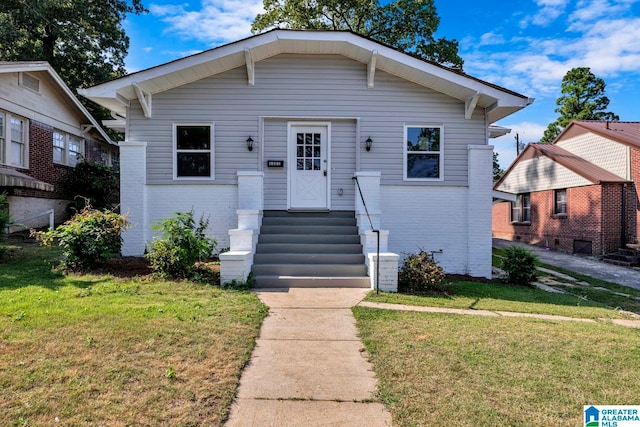 bungalow-style house with a front yard