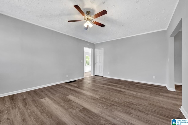 empty room featuring dark wood finished floors, baseboards, a ceiling fan, and a textured ceiling
