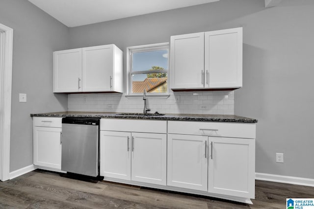 kitchen with a sink, decorative backsplash, dark stone countertops, dishwasher, and white cabinets