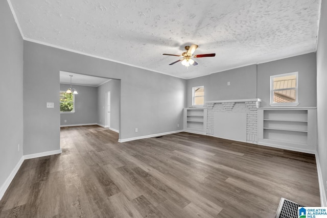 unfurnished living room with baseboards, wood finished floors, a ceiling fan, and crown molding