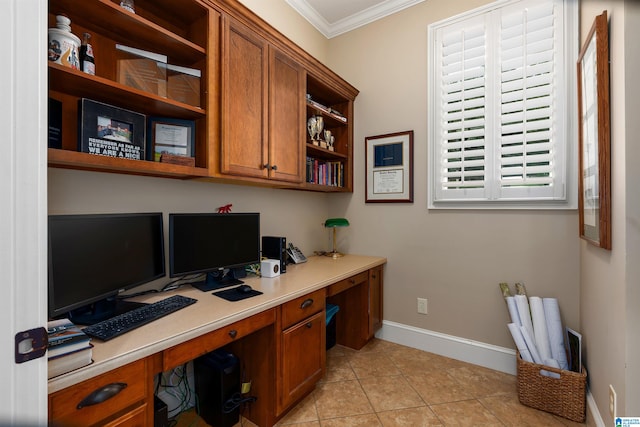 office space with light tile patterned floors, built in desk, and ornamental molding