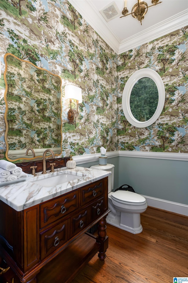 bathroom with crown molding, vanity, toilet, and wood-type flooring