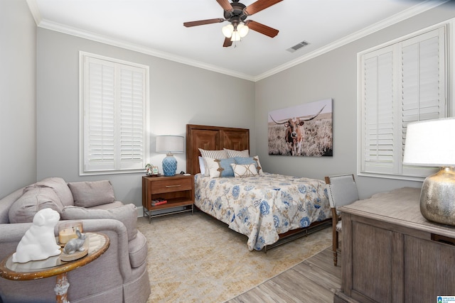 bedroom featuring light hardwood / wood-style floors, ornamental molding, and ceiling fan