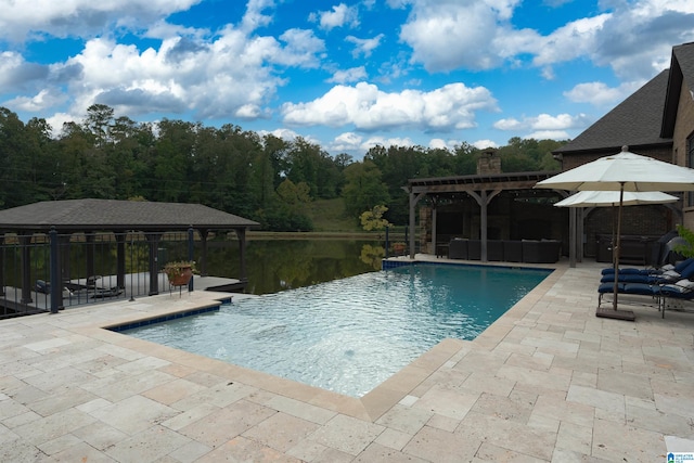 view of swimming pool featuring a water view, a pergola, and a patio area