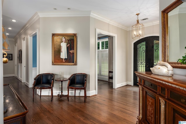 foyer featuring a notable chandelier, french doors, dark hardwood / wood-style floors, and ornamental molding