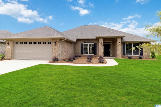 view of front of property featuring a garage and a front lawn