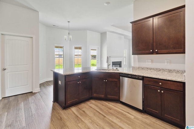 kitchen featuring hanging light fixtures, sink, dark brown cabinets, dishwasher, and light hardwood / wood-style floors