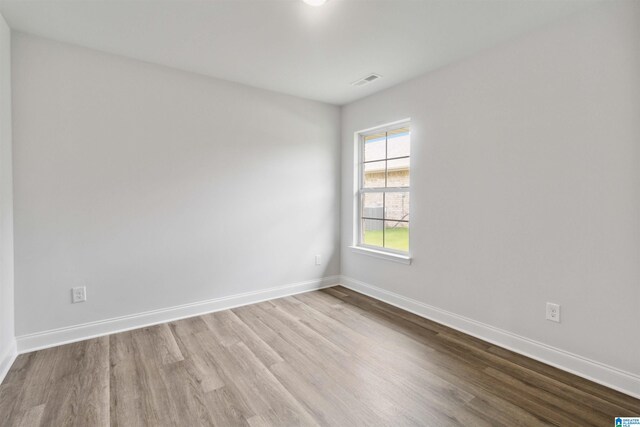 unfurnished room with light hardwood / wood-style flooring