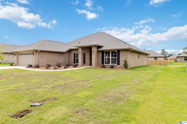 view of front of house with a front yard and a garage