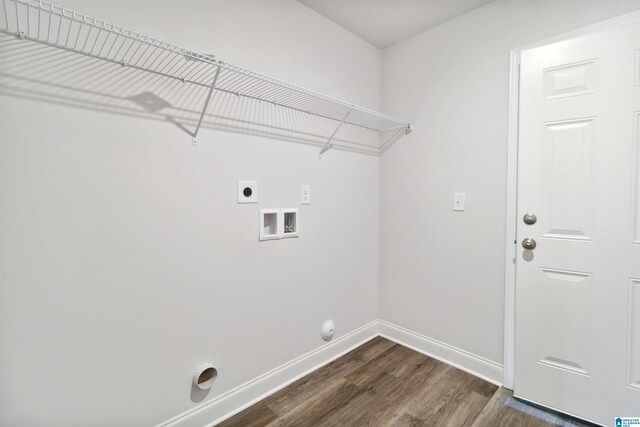 clothes washing area featuring dark wood-type flooring, hookup for an electric dryer, gas dryer hookup, and hookup for a washing machine