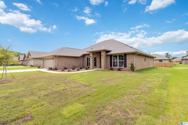 view of front of property featuring a front yard and a garage