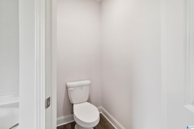 bathroom featuring hardwood / wood-style floors and toilet